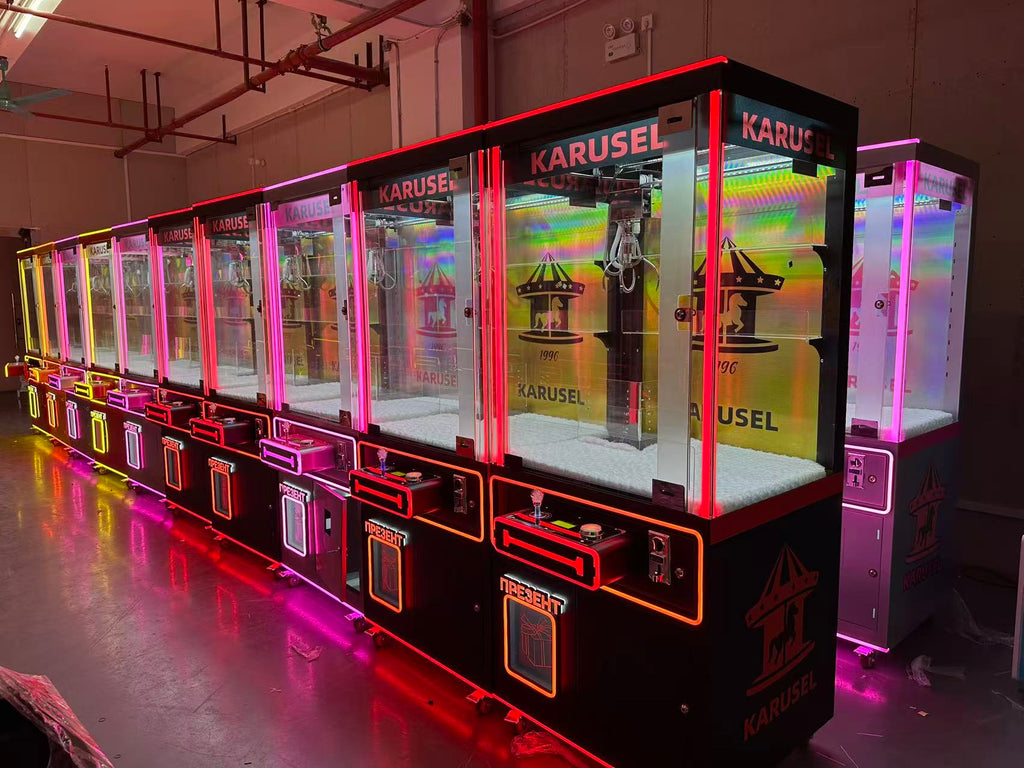 Video game arcade with doll catching machines featuring advertising screens and holding figurines for games and gift dispensers