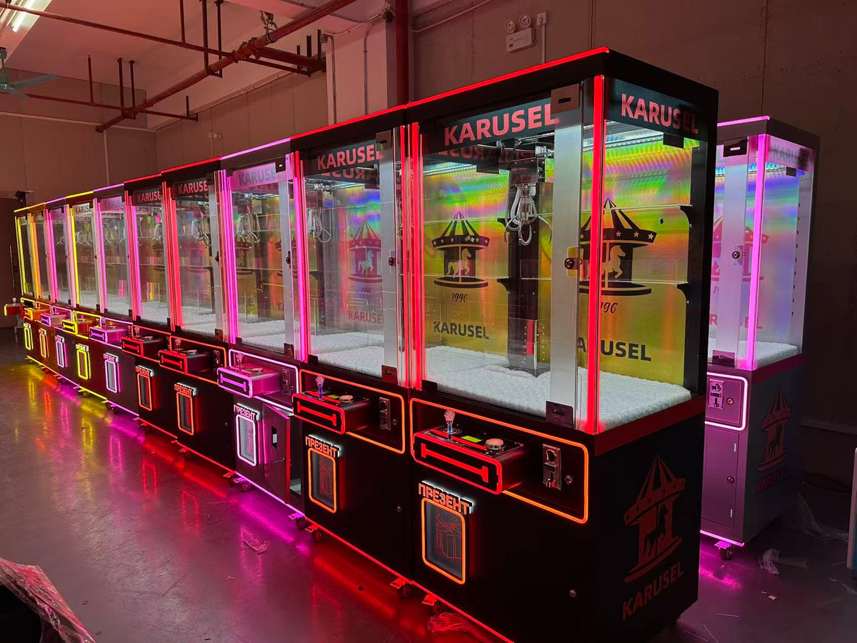 Video game arcade with doll catching machines featuring advertising screens and holding figurines for games and gift dispensers