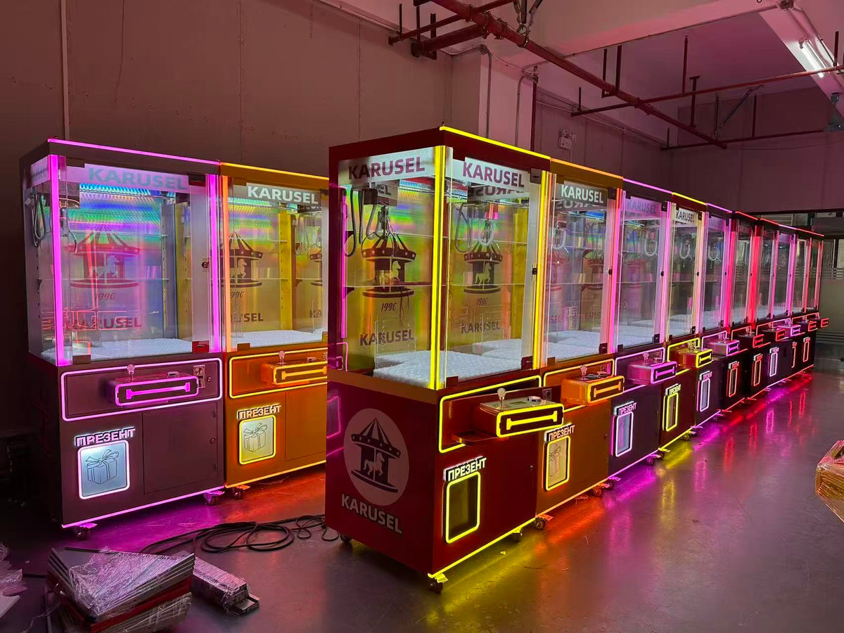 Video game arcade with doll catching machines featuring advertising screens and holding figurines for games and gift dispensers