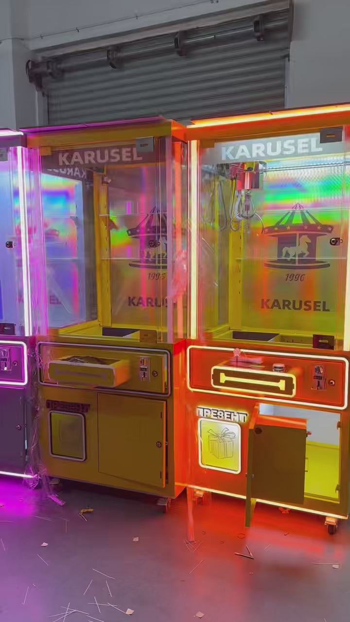 Video game arcade with doll catching machines featuring advertising screens and holding figurines for games and gift dispensers