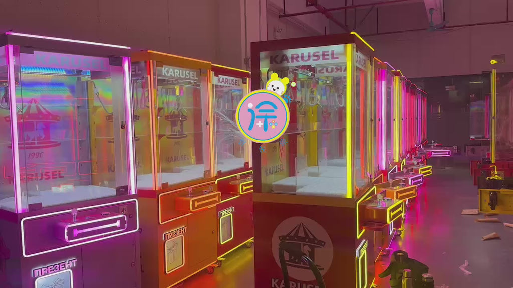 Video game arcade with doll catching machines featuring advertising screens and holding figurines for games and gift dispensers