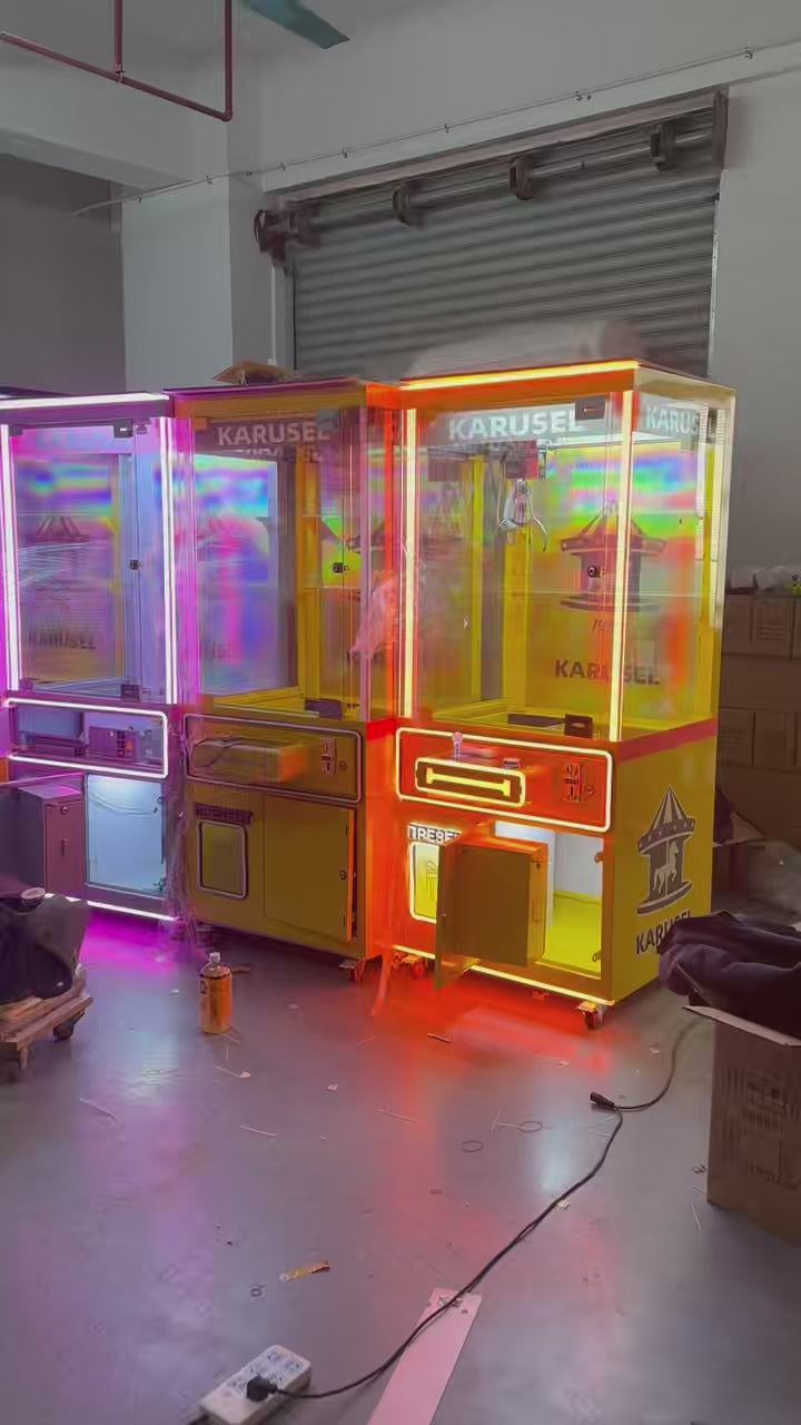 Video game arcade with doll catching machines featuring advertising screens and holding figurines for games and gift dispensers